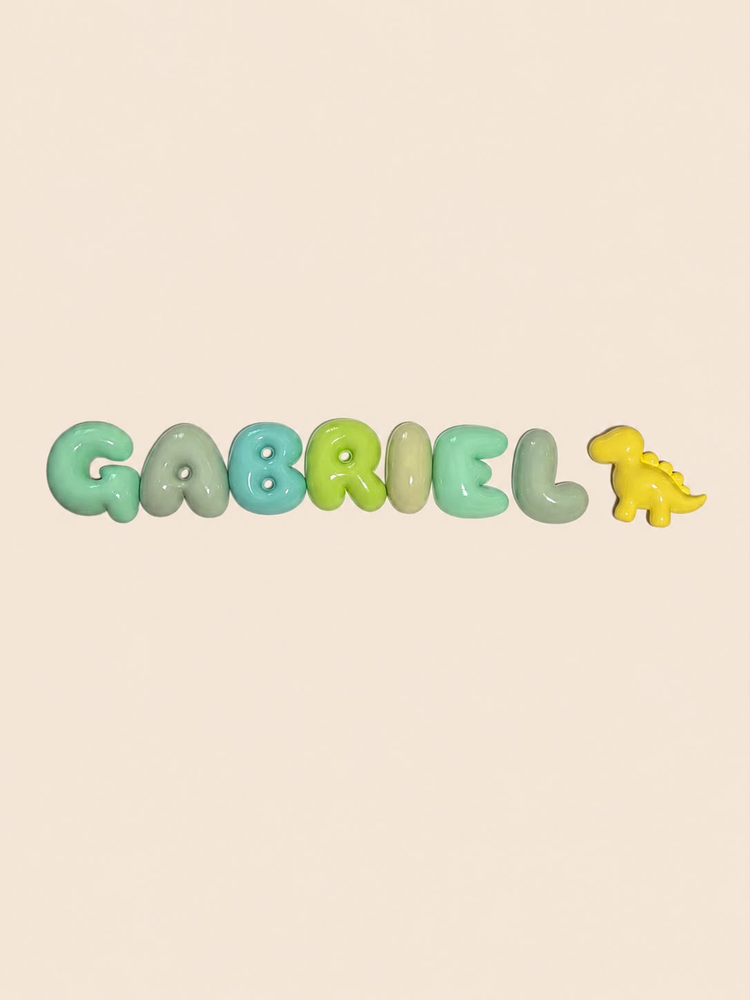 Nombre Gabriel en letras bubble en tonos verdes con un dinosaurio amarillo