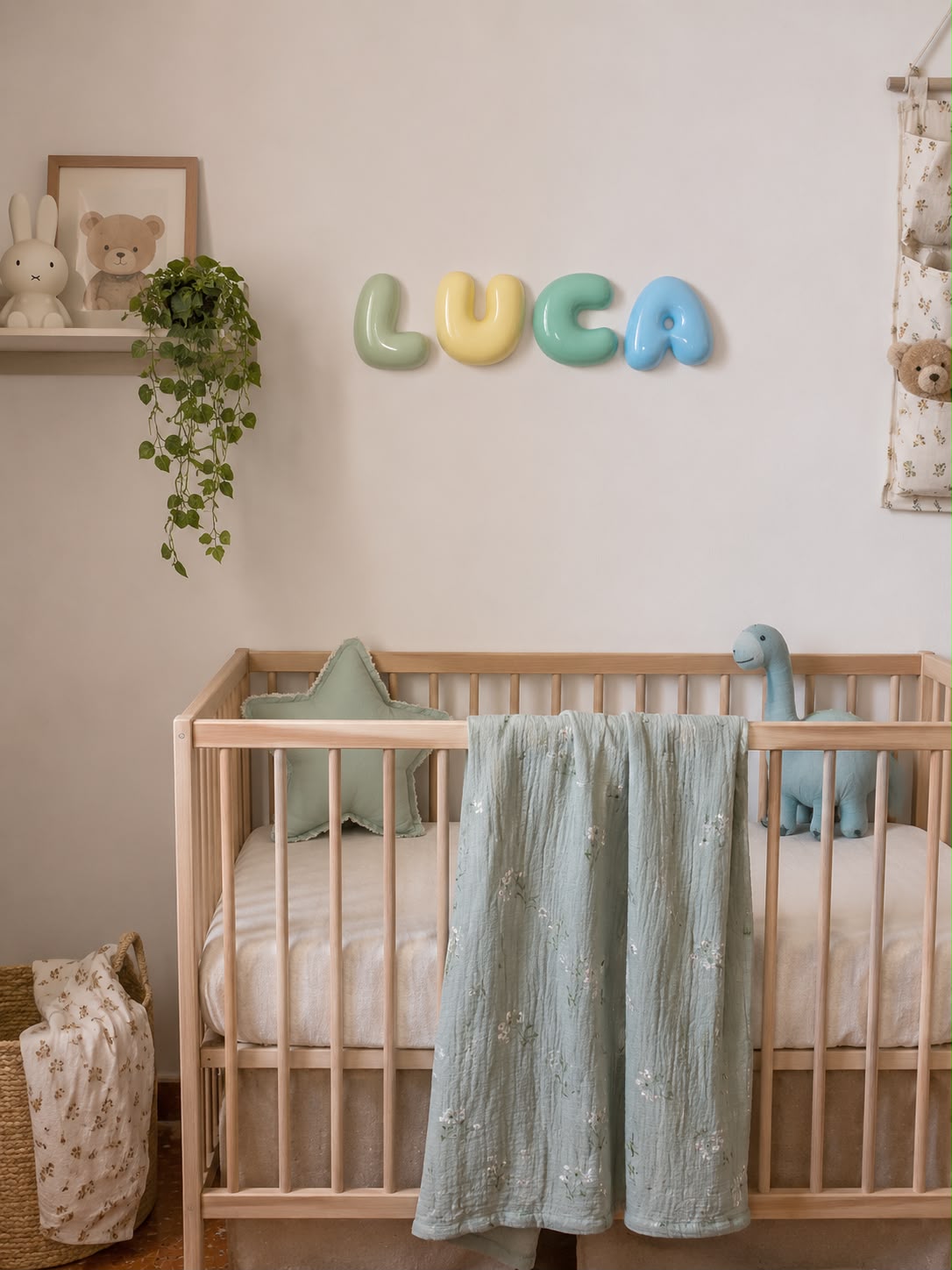 Nombre Luca en letras bubble verde, amarillo, menta y azul sobre la cuna